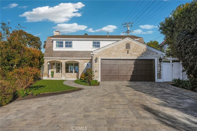3024 Via Rivera, Palos Verdes Estates, CA 90274 - view of front of home with a porch, decorative driveway, a chimney, an attached garage, and stone siding
