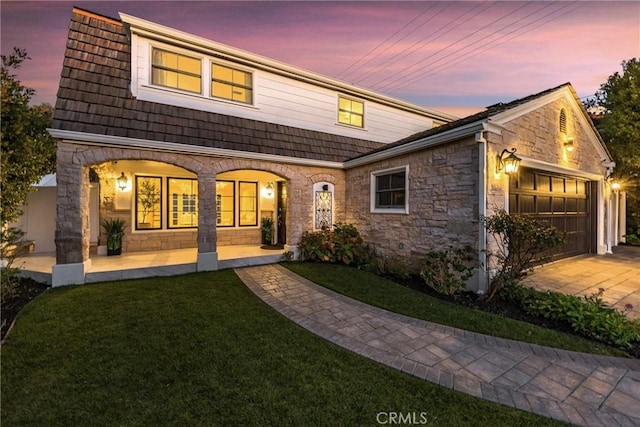 3024 Via Rivera, Palos Verdes Estates, CA 90274 - view of front of property with stone siding, an attached garage, covered porch, and a front lawn
