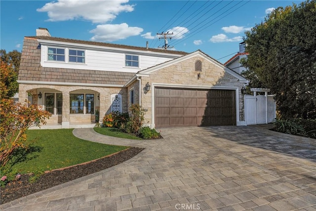 3024 Via Rivera, Palos Verdes Estates, CA 90274 - view of front facade featuring stone siding, a chimney, a garage, and decorative driveway