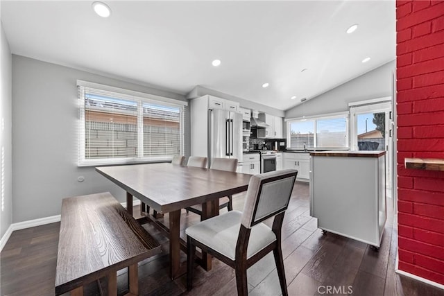 dining area featuring lofted ceiling, recessed lighting, dark wood finished floors, and baseboards