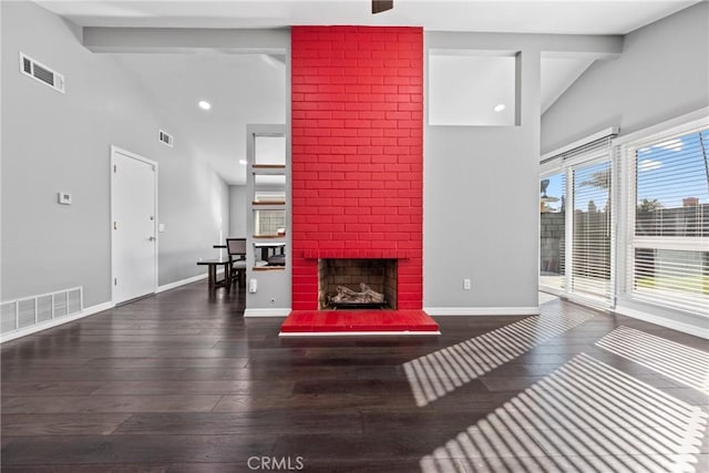 living area featuring vaulted ceiling with beams, baseboards, and visible vents