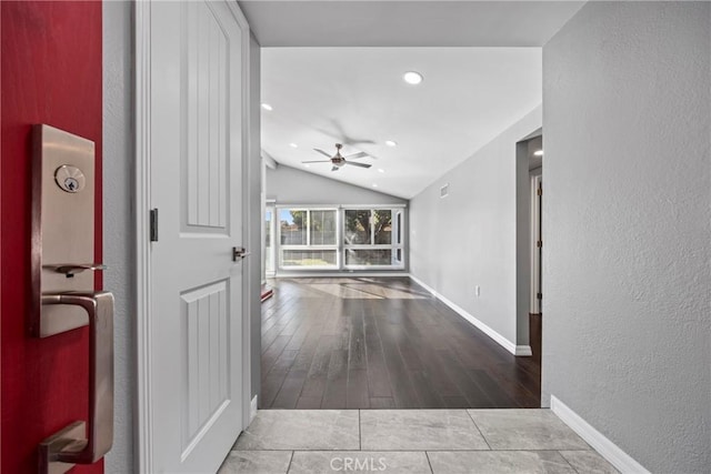 corridor featuring visible vents, baseboards, wood finished floors, vaulted ceiling, and recessed lighting