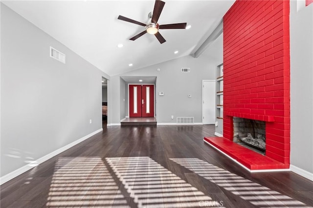 unfurnished living room with lofted ceiling with beams, wood finished floors, and visible vents