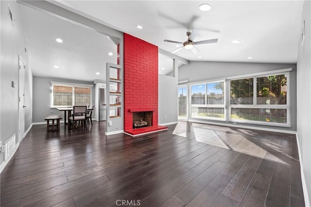 unfurnished living room with recessed lighting, a brick fireplace, vaulted ceiling, wood finished floors, and baseboards