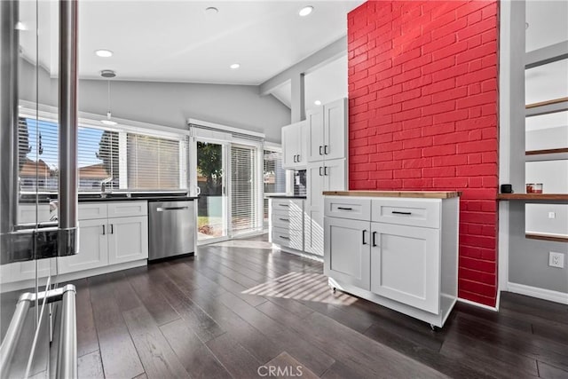 kitchen with white cabinets, vaulted ceiling, dark wood-style flooring, and dishwasher