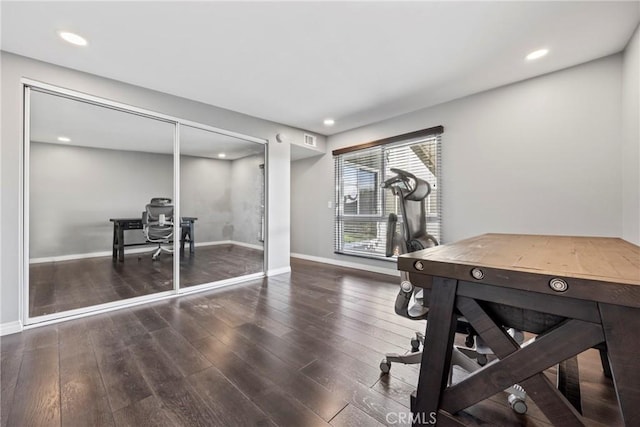 workout area with baseboards, wood finished floors, and recessed lighting