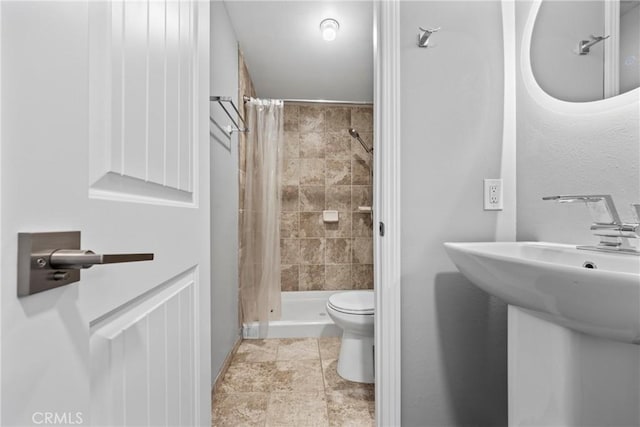 full bathroom featuring a shower stall and toilet