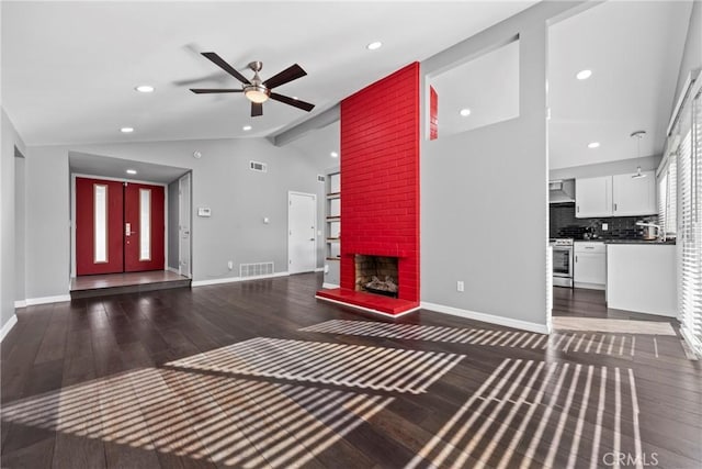 unfurnished living room with vaulted ceiling with beams, wood finished floors, and baseboards