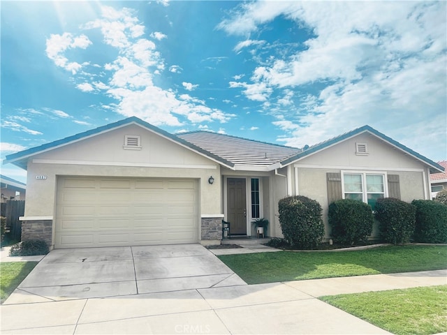 4907 Durant Way, Merced, CA 95348 - ranch-style home featuring stone siding, a garage, stucco siding, a tiled roof, and driveway