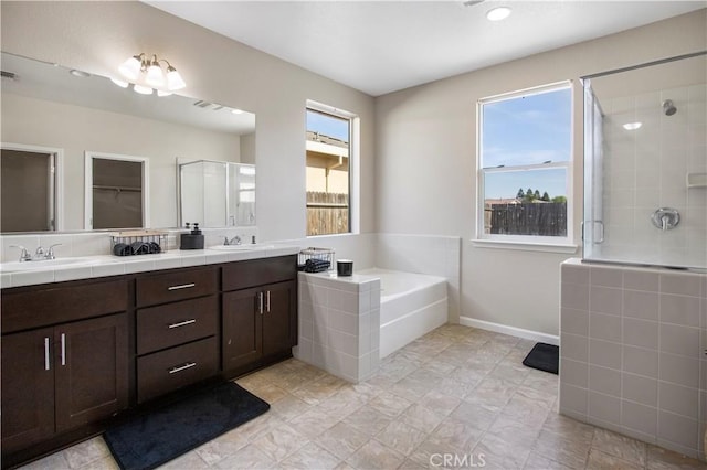 4907 Durant Way, Merced, CA 95348 - full bathroom featuring a sink, double vanity, a stall shower, and a garden tub
