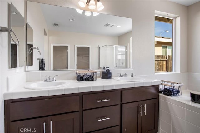 4907 Durant Way, Merced, CA 95348 - full bath featuring a sink, a stall shower, double vanity, and visible vents