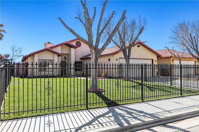 mediterranean / spanish-style home featuring a fenced front yard, a chimney, stucco siding, an attached garage, and a front lawn