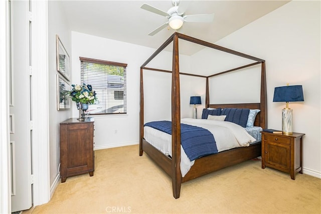 bedroom with a ceiling fan, light carpet, and baseboards