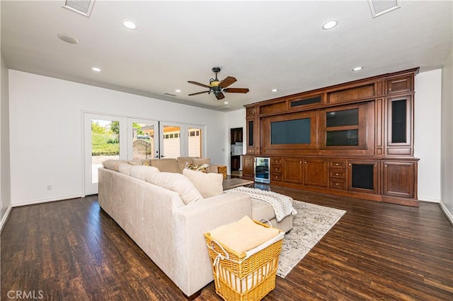 living room with recessed lighting, dark wood-style flooring, and visible vents