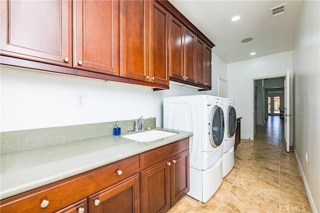 clothes washing area featuring recessed lighting, cabinet space, a sink, independent washer and dryer, and baseboards