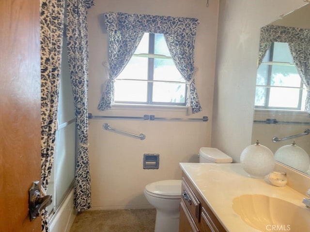 full bathroom featuring toilet, shower / bath combination with curtain, vanity, and a healthy amount of sunlight