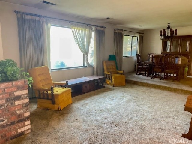 living area with carpet floors and visible vents