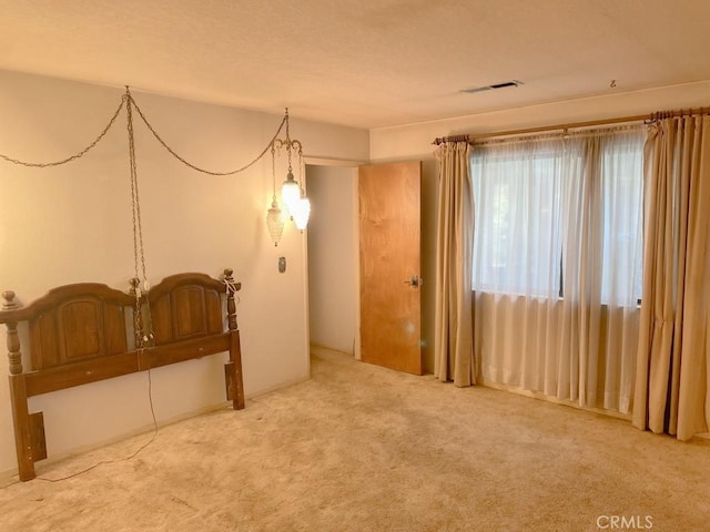 empty room featuring visible vents and carpet flooring