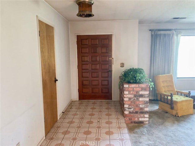 foyer entrance with visible vents