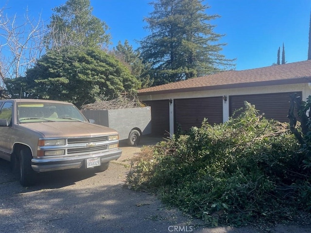 view of home's exterior with roof with shingles