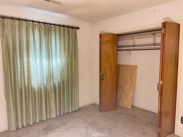 unfurnished bedroom featuring carpet floors and a closet