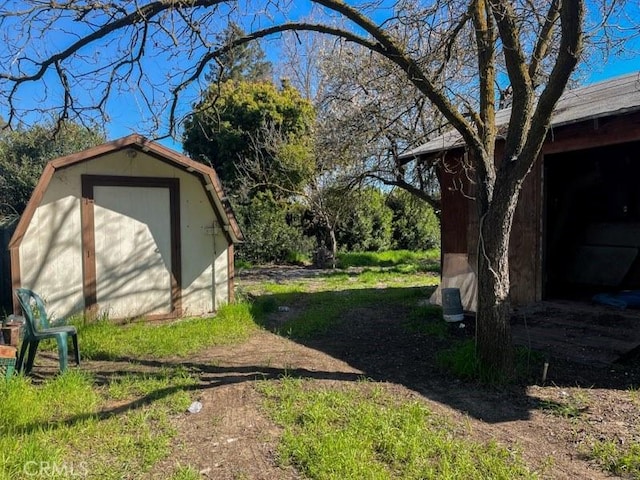 view of yard featuring a shed and an outbuilding