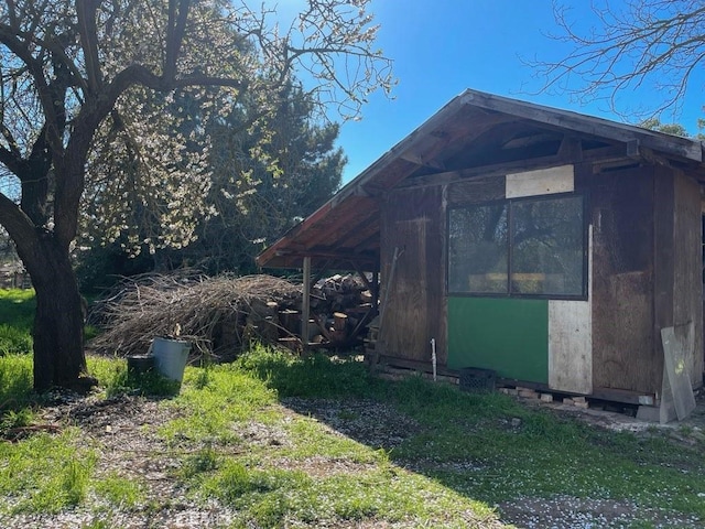 view of side of property featuring an outbuilding