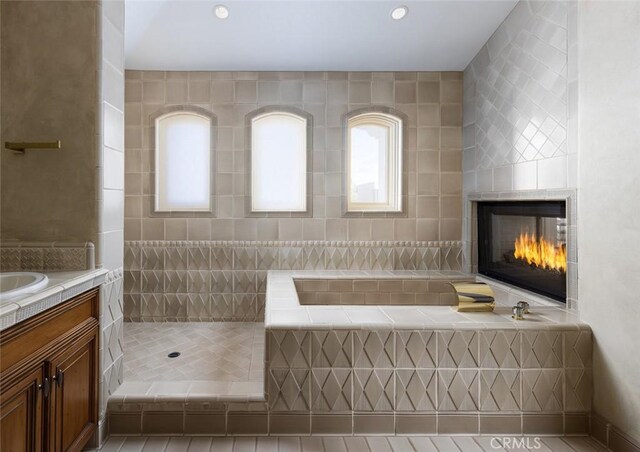 3824 Vista Blanca, San Clemente, CA 92672 - full bathroom featuring a multi sided fireplace, vanity, a bath, a tile shower, and recessed lighting