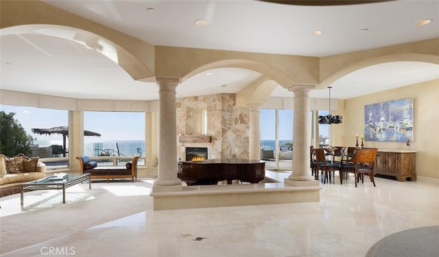 3824 Vista Blanca, San Clemente, CA 92672 - living room with ornate columns, a lit fireplace, plenty of natural light, and recessed lighting