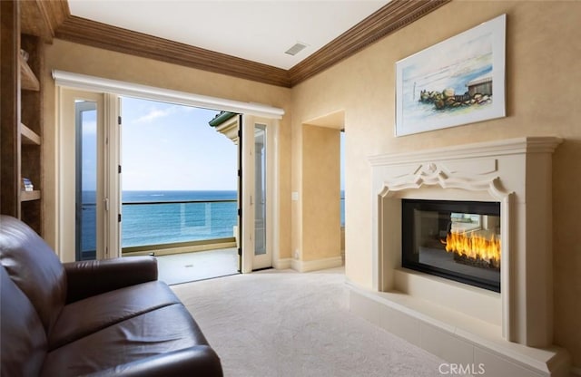3824 Vista Blanca, San Clemente, CA 92672 - living room featuring carpet, a glass covered fireplace, crown molding, and a water view