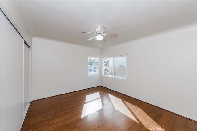 unfurnished room with ceiling fan and wood finished floors