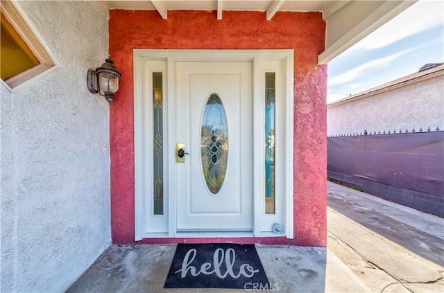 entrance to property featuring stucco siding