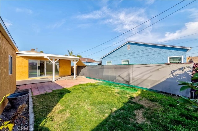 view of yard featuring fence and a patio