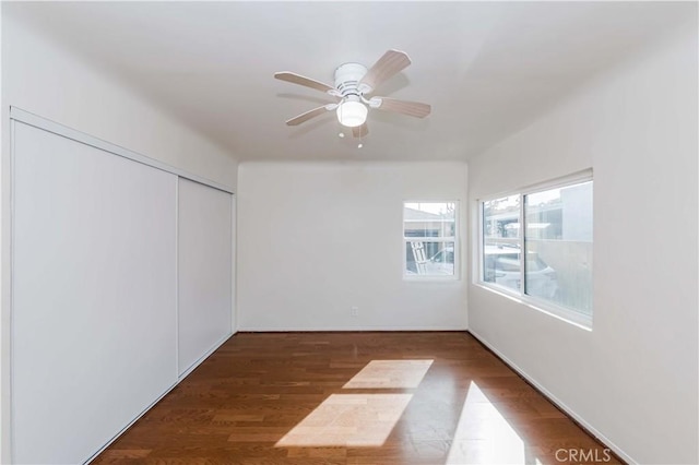 empty room with ceiling fan and wood finished floors