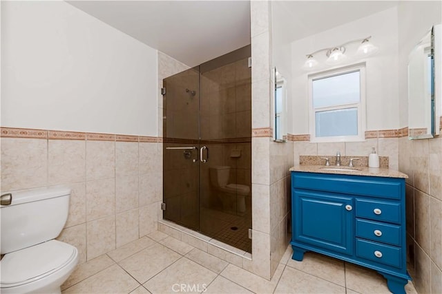 bathroom featuring a shower stall, tile walls, and tile patterned floors