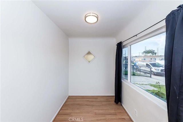 interior space featuring light wood-style floors and baseboards