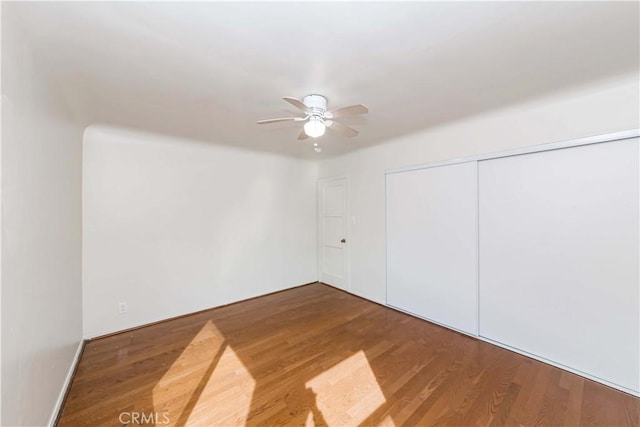 unfurnished room featuring a ceiling fan and wood finished floors