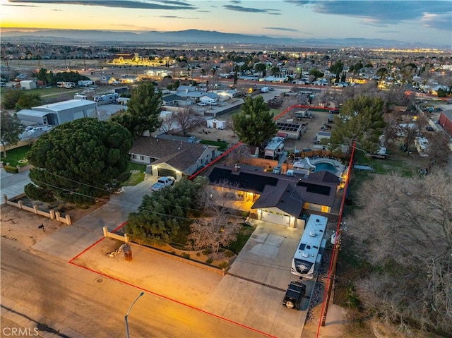 aerial view at dusk featuring a mountain view