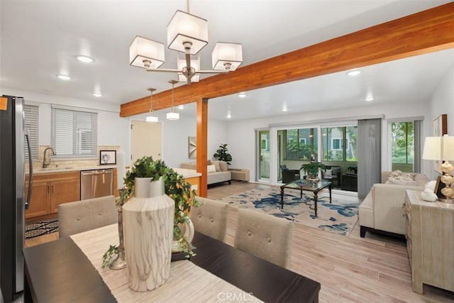 dining area with light wood finished floors, beamed ceiling, and recessed lighting