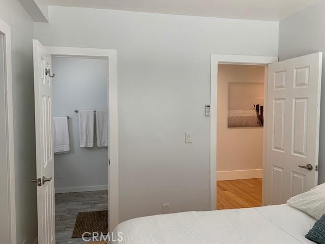 bedroom with wood finished floors and baseboards