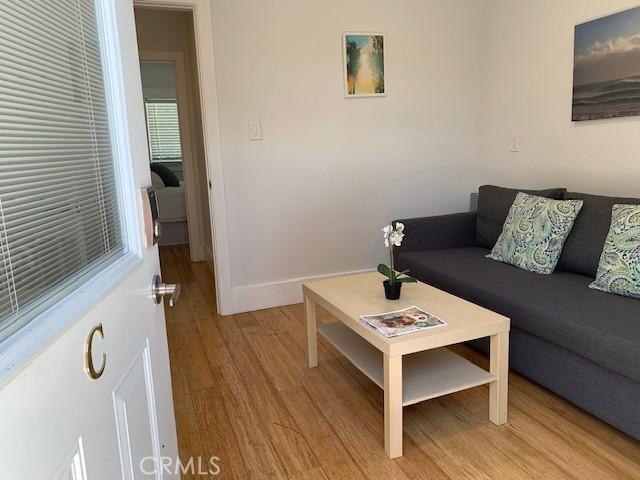 living room featuring light wood finished floors and baseboards