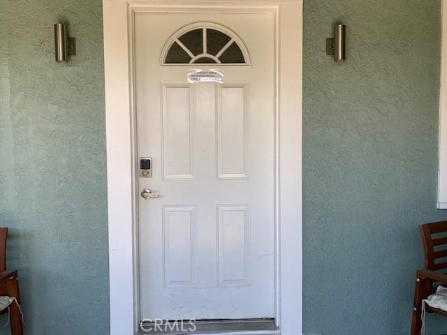 property entrance featuring stucco siding