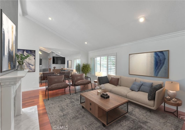 living area featuring lofted ceiling, recessed lighting, wood finished floors, baseboards, and ornamental molding