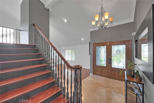 foyer featuring light tile patterned floors, stairs, crown molding, french doors, and a notable chandelier