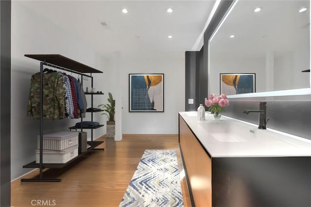 bathroom with vanity, wood finished floors, visible vents, and recessed lighting