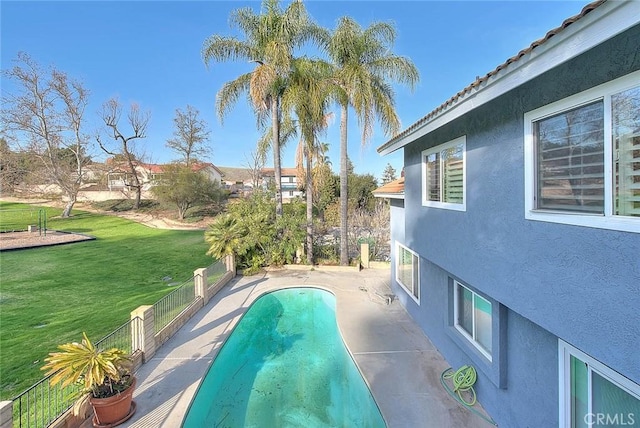 view of pool with a fenced in pool, a patio area, and a yard