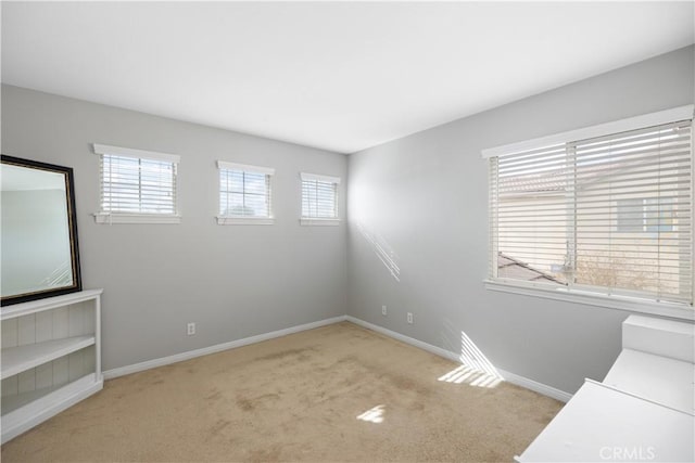 carpeted spare room with baseboards