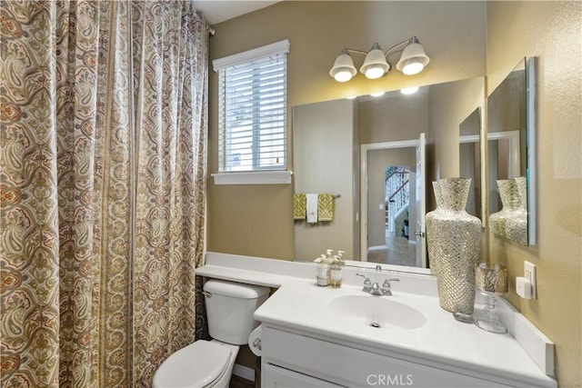 full bath featuring vanity and toilet