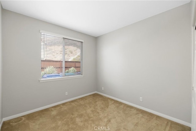 empty room with light carpet and baseboards