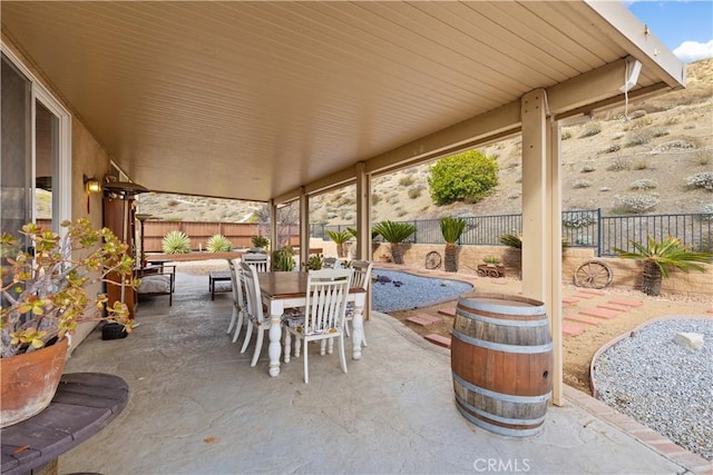 view of patio with outdoor dining space and a fenced backyard